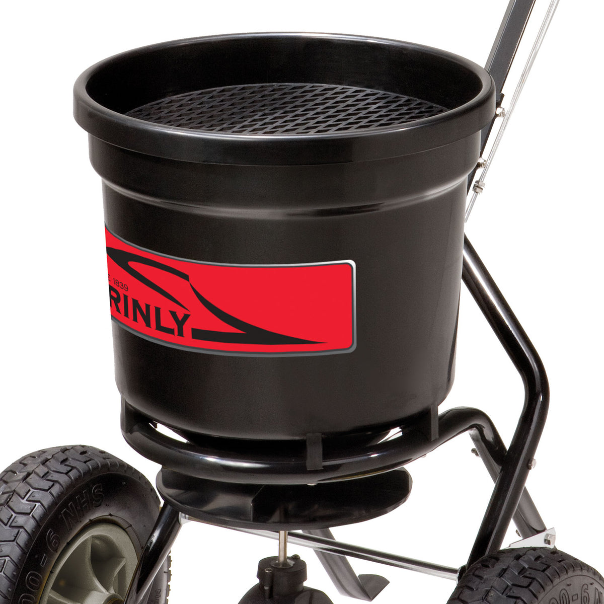 A close-up of the 50 lb. Push Spreader | P20-500BH by Brinly Parts shows its black design with a red label, two large wheels, and a top mesh screen. The broadcast spreader is mounted on a metal frame with a handle for easy maneuvering.