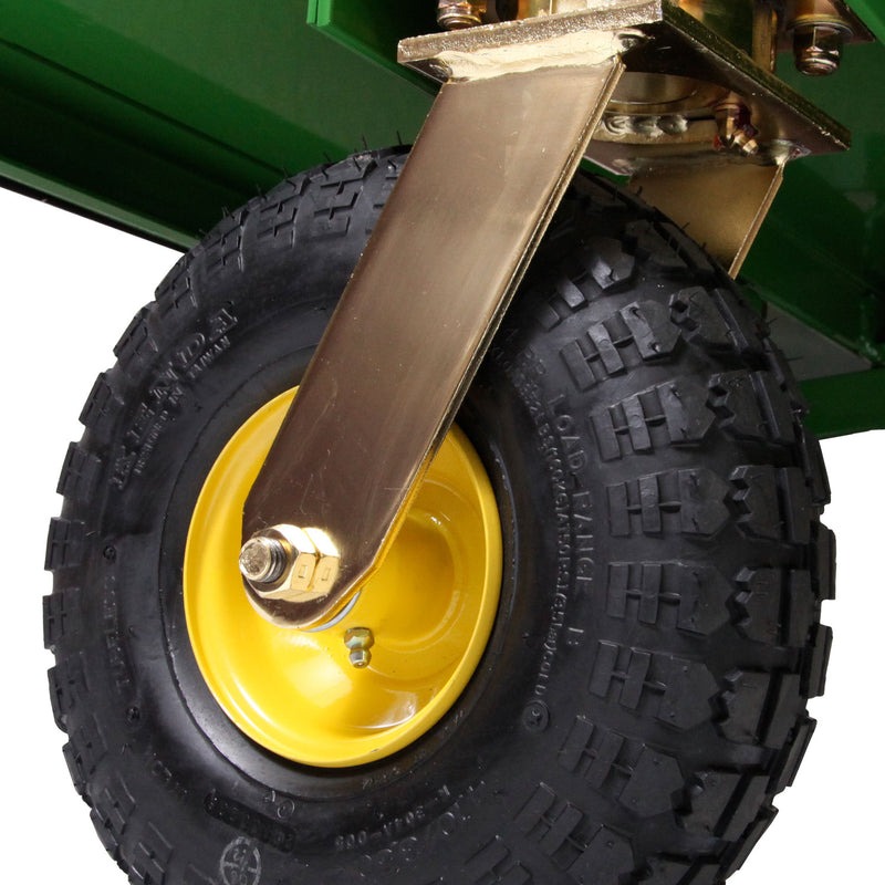 Close-up of a rugged, black rubber tire with deep treads on a yellow rim, featuring a kingpinless design, attached to a sturdy gold bracket. The background subtly hints at the John Deere MC519 Material Collection Systems signature green.