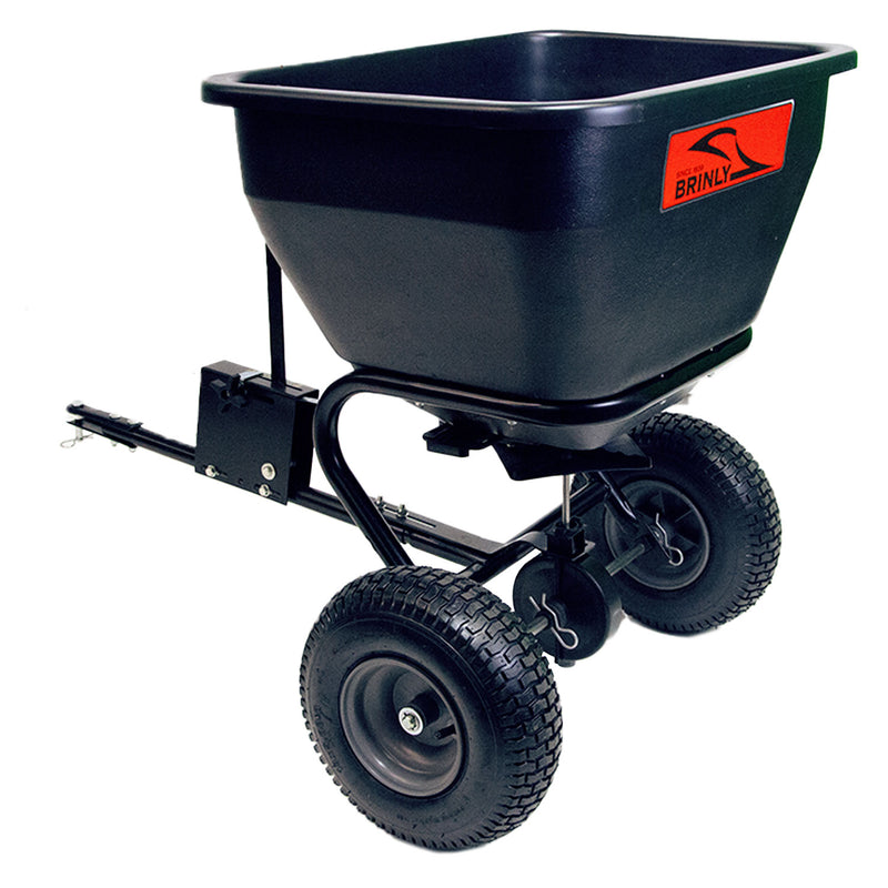 The Brinly Parts 175 Lb. Tow-Behind Spreader (BS36BH) features a rust-proof black polyethylene hopper, two large pneumatic tires, and a universal hitch for easy attachment to lawn tractors, ensuring even distribution of seeds or fertilizer on lawns.