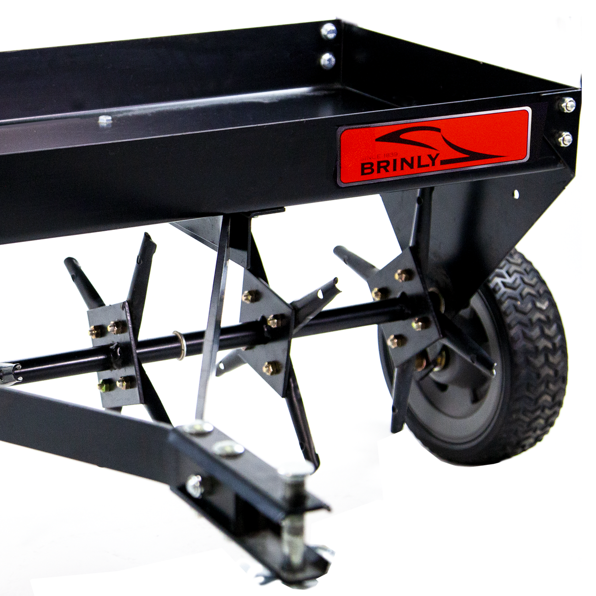 The Brinly Parts 48″ Tow-Behind Plug Aerator | PA-482BH features multiple spiked wheels, steel tines for root zone penetration, sturdy metal construction, and two large rubber tires for easy towing. It sports a black design with a red logo.