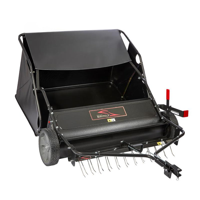 The Brinly Parts 42″ Combo Lawn Sweeper with Dethatcher (LSDT2-42BH-G) is a black and red 2-in-1 tool featuring large collection bag, side wheels, rotating brush, hitch for lawn tractor attachment, and the Brinly logo on the front.