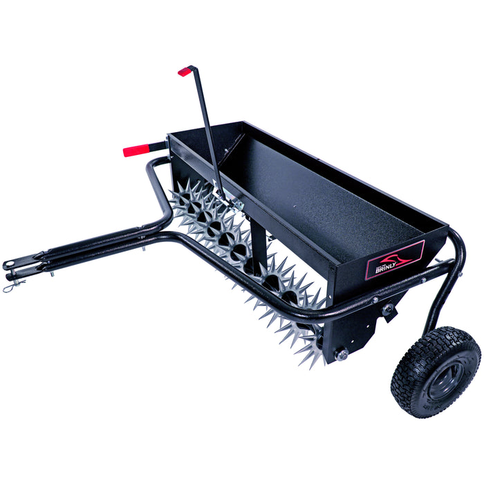 The Brinly Parts 40 Combination Aerator Spreader (AS2-40BH-G) features pneumatic tires, spiked wheels, a rectangular tray for spreading materials, and a hitch for easy tow-behind use with your lawn tractor or mower.