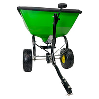 The John Deere 200 lb Tow-Behind Broadcast Spreader | LP79932 features PRO-level durability, green color, a black handle with ACCUWAY technology for precise distribution, large black tires, and a tow bar for attaching to John Deere Tow Spreaders.