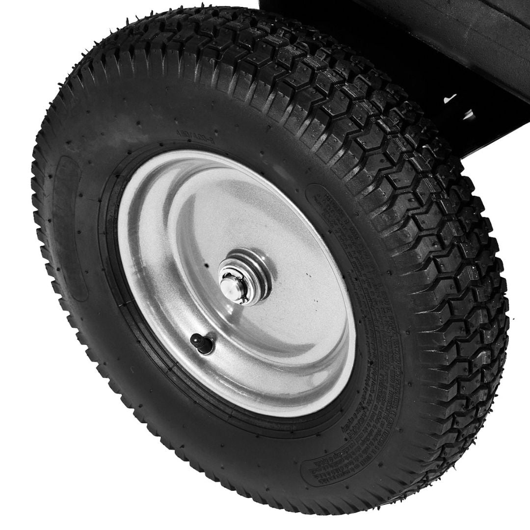Close-up of a black rubber tire with textured tread on a silver wheel rim, attached to the Brinly Parts 10 Cu. Ft. Poly Cart (PCT-101BH). The valve stem is visible near the bottom of the wheel.