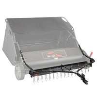 A black and gray Brinly Parts DK2-54BH dethatcher kit for 54" lawn sweepers features a collection bin, two wheels, and front metal tines; the Brinly brand appears on the front panel—ideal for efficient lawn care.