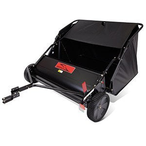 A black lawn sweeper with a collection bag, two large wheels, and a tow hitch. The device is designed for gathering leaves and debris from lawns.