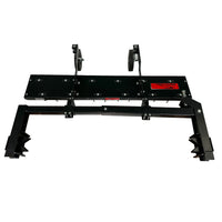 The Brinly Parts 48” ZTR Dethatcher (DTZ-481BH) is an industrial attachment for lawn maintenance. It features a flat black metal base with two top brackets, hinged components, end clamps, and a red label, suggesting its role as a dethatcher accessory for construction or mechanical tasks.