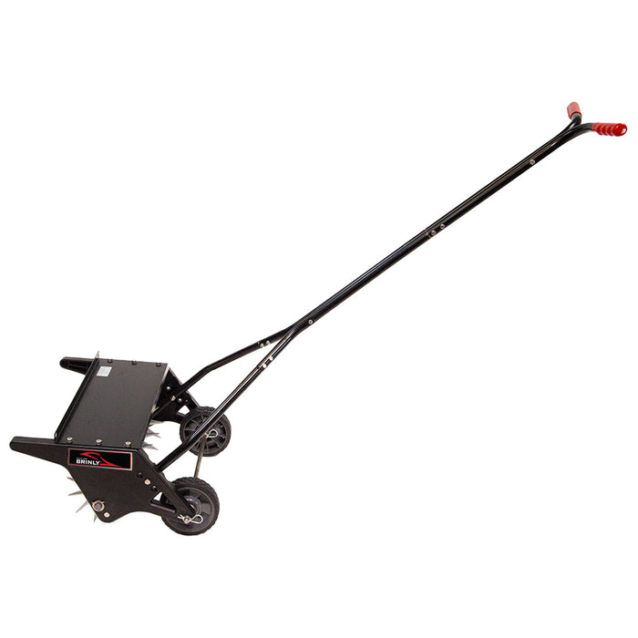 The Brinly Parts 20 Push Spike Aerator with 3D galvanized steel tines features a long handle, red grips, spiked wheel, and a small weight platform—perfect for pushing across your lawn for effective soil aeration.
