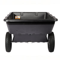 The Brinly Parts 10 Cu. Ft. Poly Cart | PCT-101BH is a black plastic dump cart with two large treaded wheels, a deep rectangular tub, and an inner left-side warning label, shown from the front on a white background.