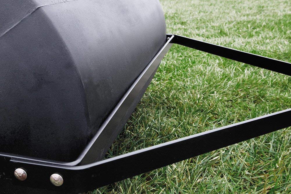 Brinly Parts 76 Gallon Tow-Behind Poly Roller (PRT-362BH), featuring a 36 width, sits on freshly mowed grass. The durable polyethylene drum smooths and levels the lawn, enhancing its vibrancy against the rollers dark finish.