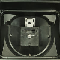 Close-up of the interior of a black plastic device with a centered metallic component featuring a small handle and slot, surrounded by angular plastic sections and four visible screws, reminiscent of the precise engineering in the Brinly Parts 70 lbs. Capacity Broadcast Ice Melt Spreader (PS10-70BH).