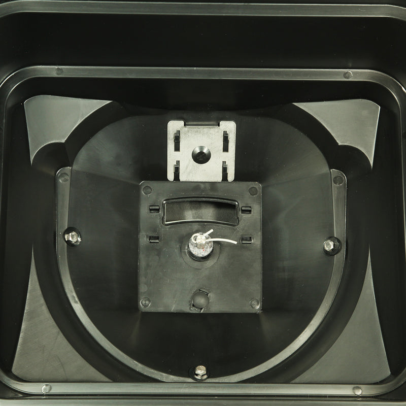 Close-up of the interior of a black plastic device with a centered metallic component featuring a small handle and slot, surrounded by angular plastic sections and four visible screws, reminiscent of the precise engineering in the Brinly Parts 70 lbs. Capacity Broadcast Ice Melt Spreader (PS10-70BH).