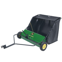 The John Deere 42 in. 24 cu. ft. Tow-Behind Lawn Sweeper features a green and black design with yellow wheels, a sturdy metal frame, and an easy-to-attach hitch for efficiently collecting leaves and grass across a 42 in. path, complete with the brands logo on the front.