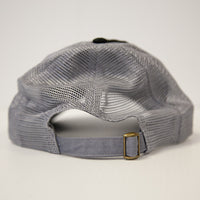 A close-up shows the adjustable strap with brass buckle on the Brinly Parts Gray & Black Baseball Cap, featuring a mesh back, set against a plain white background.