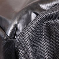 A close-up of a textured black corner seam reminiscent of the John Deere MC519 Material Collection System | LP49228 highlights its durable fabric with a crisscross pattern and slightly reflective finish, emphasizing robustness and hauling capacity.