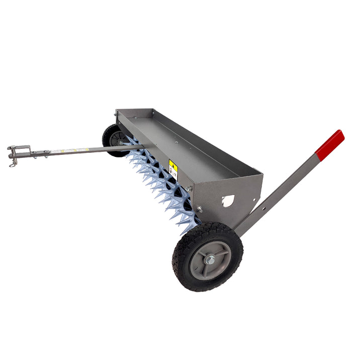 The Brinly Parts 40″ Tow-Behind Spike Aerator in Hammered Gunmetal features a metal design with a long tow bar and two sturdy transport wheels. Its sharp steel spikes and vibrant red handle grip make it perfect for efficient soil aeration and maintaining healthy lawns.