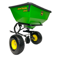 The John Deere 200 lb Tow-Behind Broadcast Spreader, LP79932, features two large black tires with yellow hubs, a black handle and frame on a white background. This durable tool is designed for precision with advanced ACCUWAY technology.