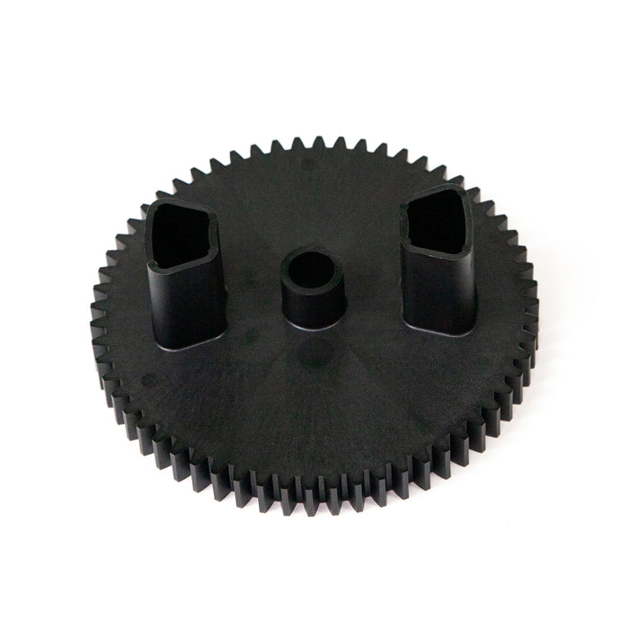 The Brinly Parts R-2280 is a black, round drive gear with 60 evenly spaced teeth, featuring two rectangular and one circular hole at its center for seamless component connection. Its surface is matte and smooth.