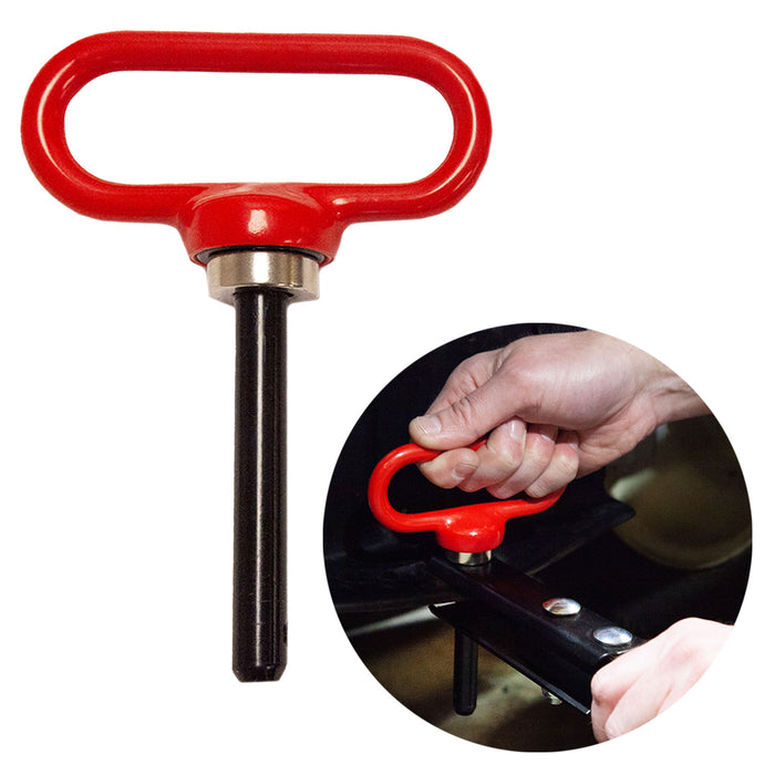 The Brinly Parts Magnetic Hitch Pin - 1/2 Inch is shown in red with a handle. A circular close-up highlights a hand gripping the handle, inserting it into a hitch receiver—ideal for securing tow-behind equipment.